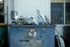 A metal recycling bin with car parts outside a building in Brisbane, Australia.